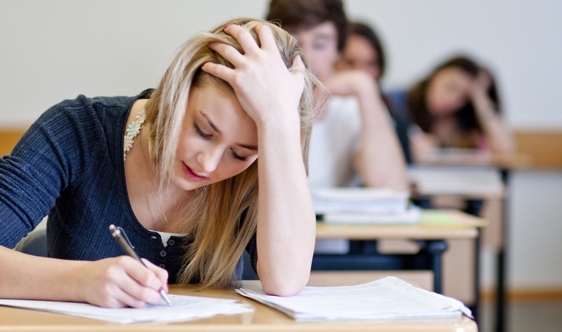 Student working on homework in classroom