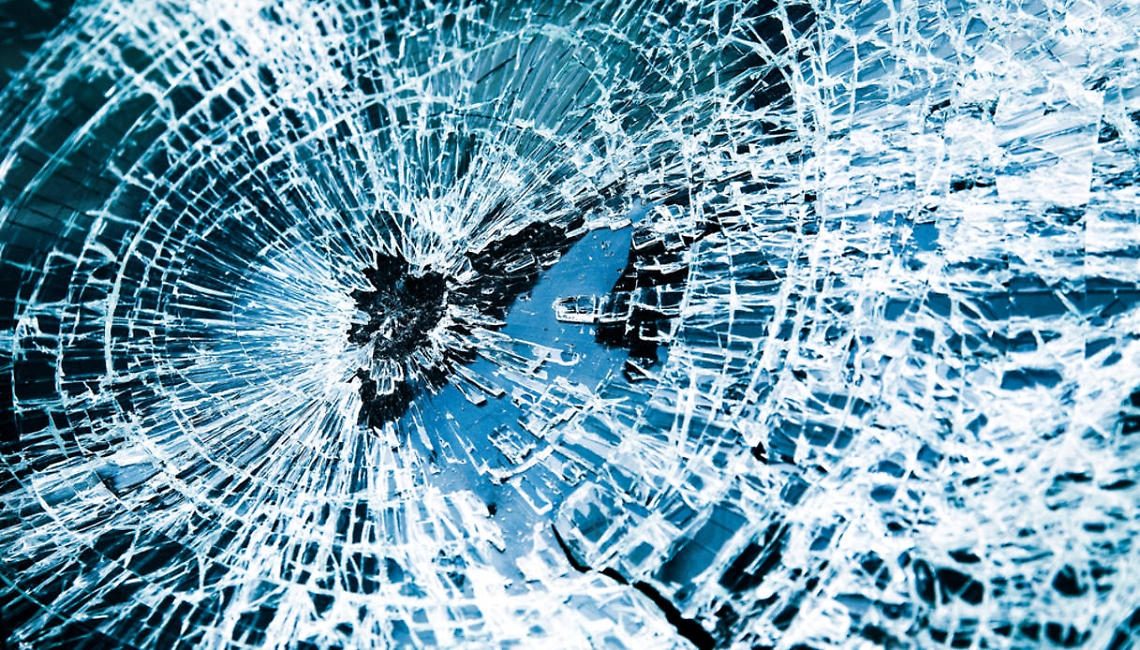 Broken car windshield. Tint blue