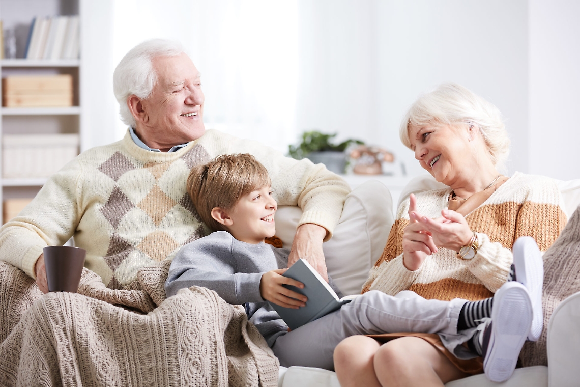 Grandparents reading to grandson
