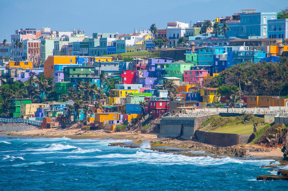 Colorful houses line the hill side overlooking the beach in San Juan, Puerto Rico.