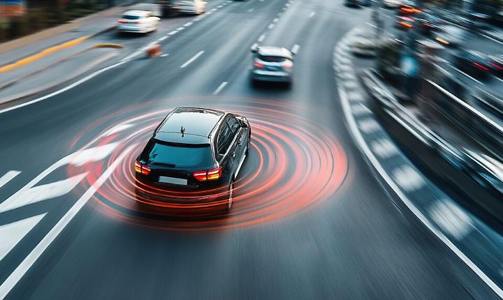 A modern car braking automatically to avoid a collision, with the driver alerted by an advanced warning system