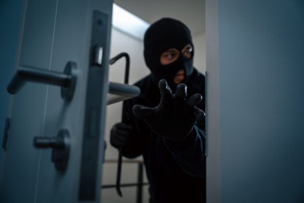 thief in uniform black jacket various action housebreak the robber terrorism criminal escapes with