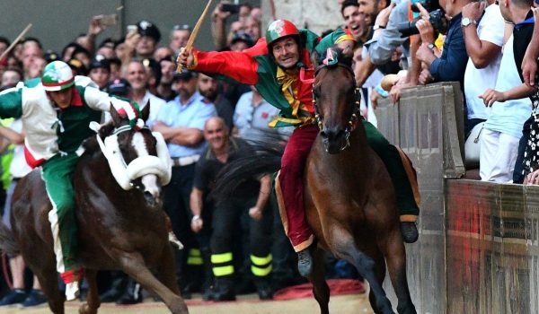 Jockey of the contrada "Drago" Andrea Mari (R) competes with his horse Rocco Nice and wins 
the historical Italian horse race Palio di Siena on July 2, 2018, in Siena. / AFP PHOTO / Vincenzo PINTO