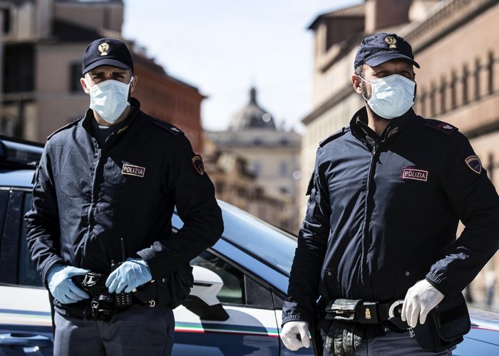 Italian police officers wearing protective masks out checks on motorists and pedestrians due to the Coronavirus emergency  in Rome, Italy, 12 March 2020. Tough lockdown measures kicked in throughout Italy on 12 March after Prime Minister Giuseppe Conte announced late on 11 March that all non-essential shops should close as part of the efforts to contain the ongoing pandemic of the COVID-19 disease caused by the SARS-CoV-2 coronavirus. ANSA/ANGELO CARCONI