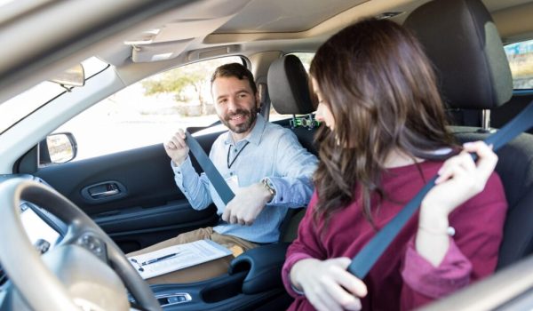 Instructor And Student Fastening Car Seatbelts